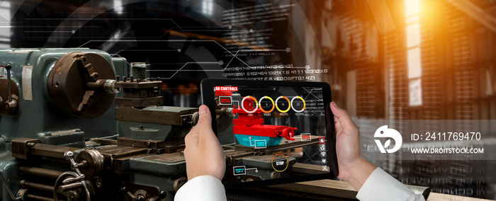 Engineer use augmented reality software in smart factory production line with automated application . Futuristic machinery in working in concept of Industry 4.0 or 4th industrial revolution.