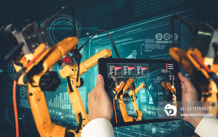 Engineer controls robotic arms by augmented reality industry technology application software. Smart robot machine in future factory working in concept of Industry 4.0 or 4th industrial revolution.