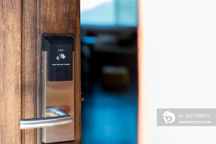 Smart card door key lock system in hotel. Hotel electronic lock on wooden door. Entrance door with electronic card lock security. Digital door lock security systems for access protection of hotel