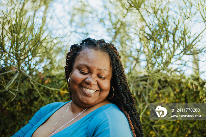 plus size African American woman looking down smiling