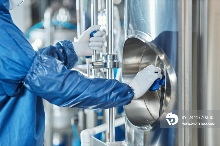 Close up of worker wearing protective gear operating equipment