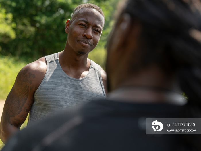 Two men talking after exercising outdoors