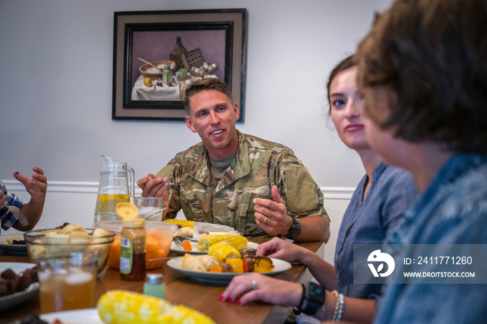 Air Force service member fixes and eats dinner with family.