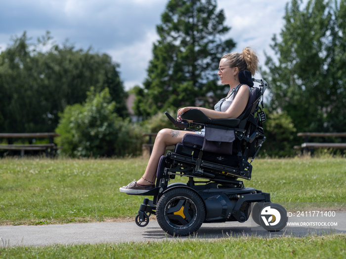 Woman in electric wheelchair going on walk