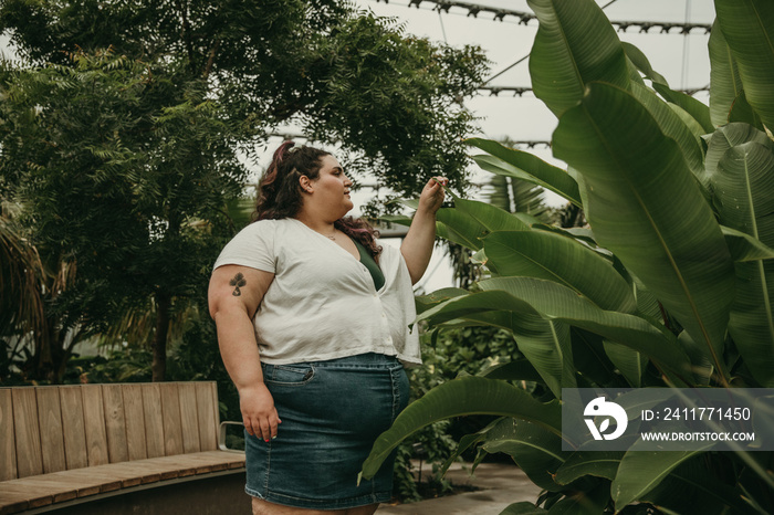 plus size Jewish woman looks at plants