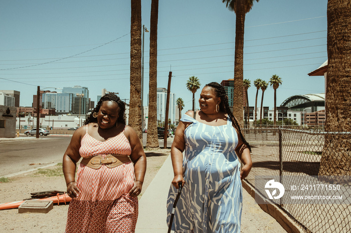 2 African American women walk down the street