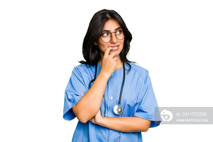 Young nurse Indian woman isolated relaxed thinking about something looking at a copy space.