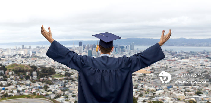education, graduation and people concept - happy male graduate student in mortar board and bachelor gown celebrating success from back over singapore city background
