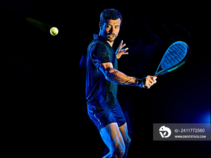 one caucasian Paddle tennis player man studio shot isolated on black background with light painting blur effect