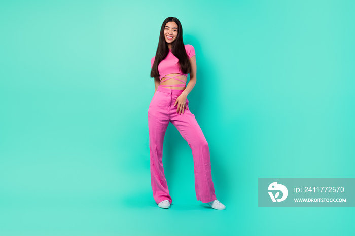 Full size picture of good looking female in trendy street style pink outfit set isolated on turquoise color background