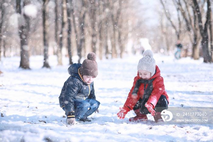 Kids walk in the park first snow