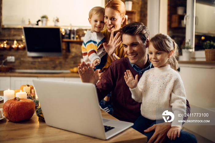 Happy family using laptop and making video call on Thanksgiving at home.