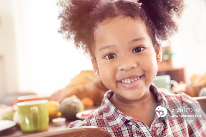 Little Girl Eating  and smile Thanksgiving Celebration Concept.Merry Christmas and Happy Holiday. Cute little child girl smile.