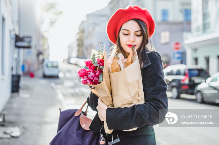 Frenchwoman with baguettes on the street in beret