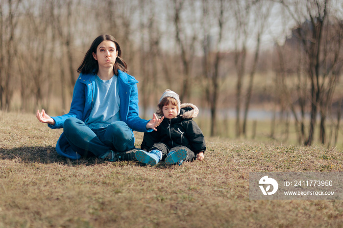 Mother in Lotus Pose Trying to Relax Outside