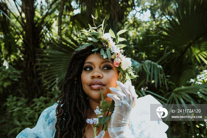 portrait of a plus size Black woman holding flowers looking to the side