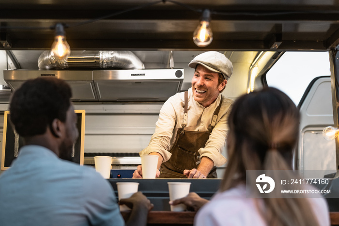 Happy multiracial people buying meal from street food truck market - Modern business and take away concept