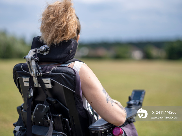 Woman in electric wheelchair going on walk