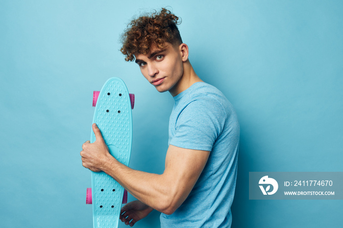 handsome guy skateboard in hand in blue t-shirts Lifestyle unaltered