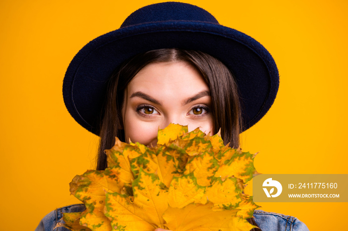 Close-up portrait of her she nice-looking sweet attractive lovely cheerful cheery straight-haired lady hiding behind orange leaves isolated over bright vivid shine yellow background