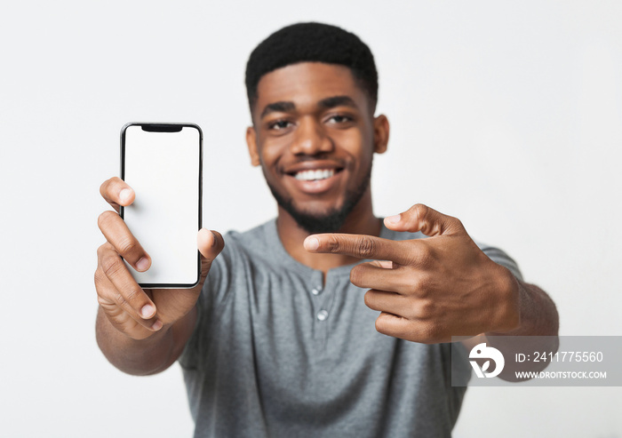 Happy black man holding latest slim smartphone