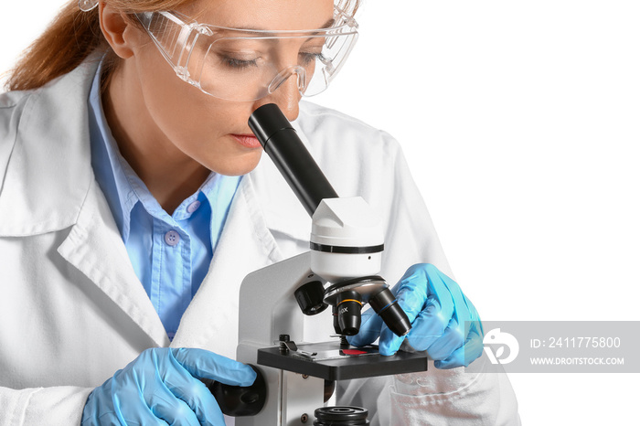 Scientist working with microscope against white background