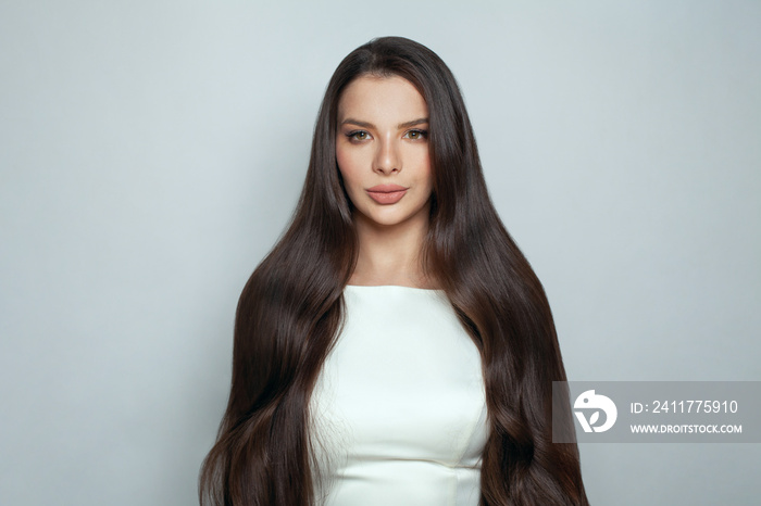 Perfect woman with long smooth straight healthy silky hair on white background. Haircare and beauty concept