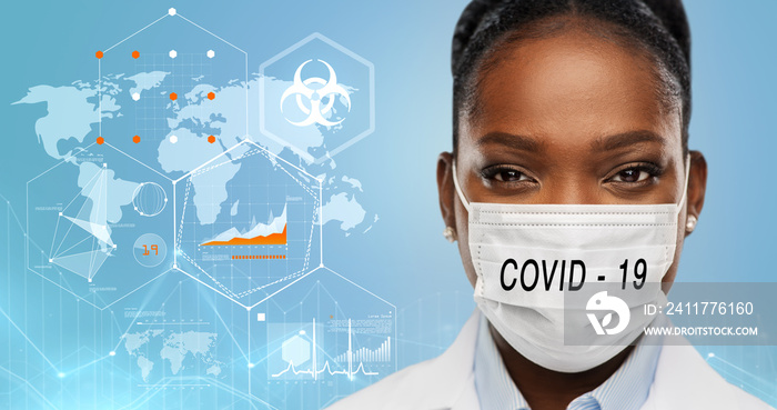 health, medicine and coronavirus epidemy concept - african american female doctor wearing face protective medical mask over world map with charts and biohazard symbol on blue background