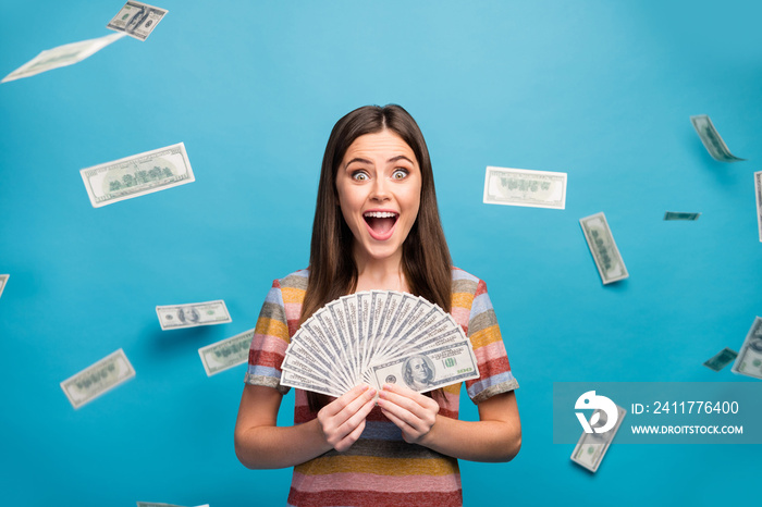 Close-up portrait of her she nice lovely pretty amazed crazy overjoyed cheerful cheery girl holding in hand fan cashback sale discount isolated over bright vivid shine vibrant blue color background