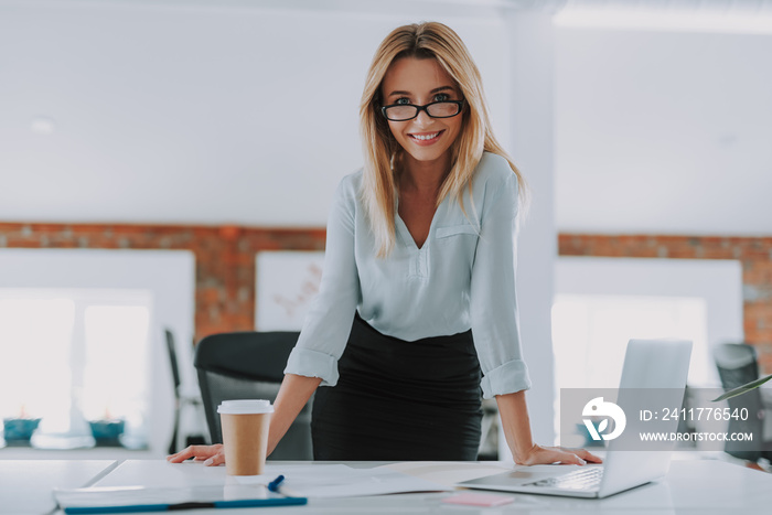 Waist up of the businesswoman looking confident with her hands on the table