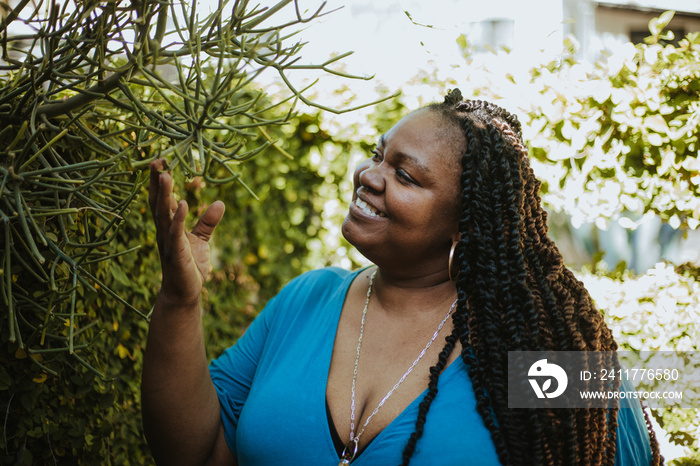 Afro Latinx Haitian American woman looking at plants