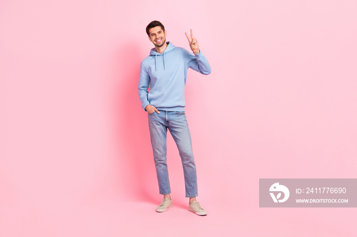 Full body length cadre of young cheerful smile confident student guy wear new collection clothes show v-sign isolated on pink color background
