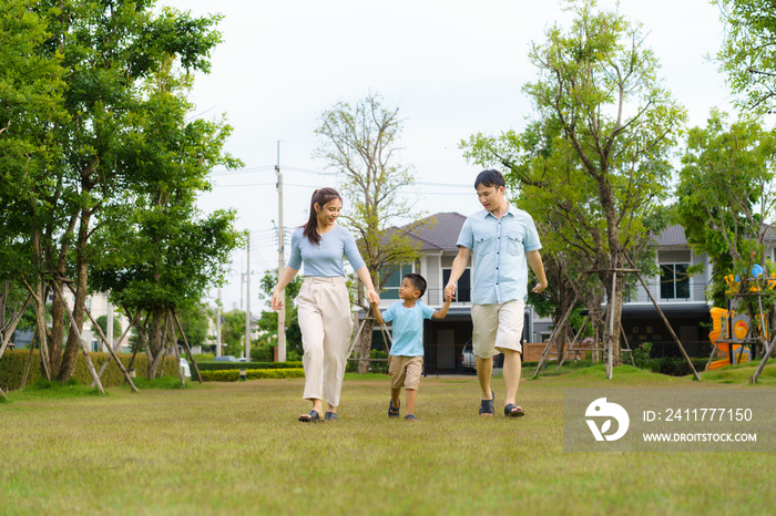 Asian family walking in yard or public park in neighborhood for daily health and well being, both physical and mental happy family.