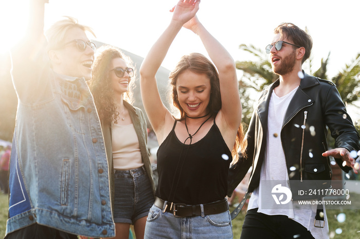 Group of young caucasian friends dancing and  having fun on music festival