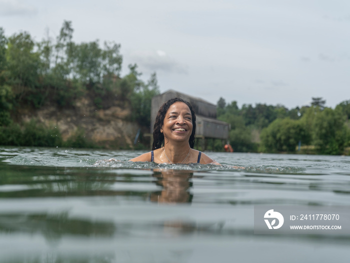 Smiling woman swimming in lake