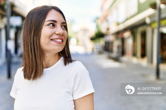 Young beautiful woman smiling happy outdoors on a sunny day of summer