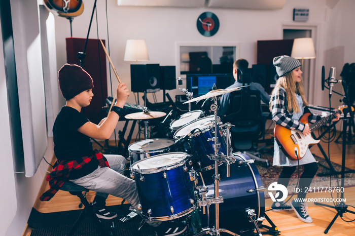 kids rock band playing in music studio