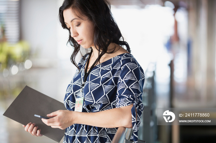 Stylish woman text messaging on cell phone.