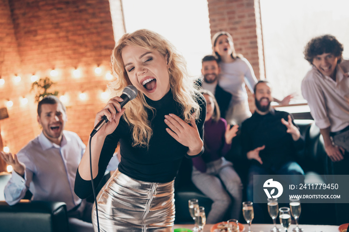 Photo of best friends clapping hands celebrating newyear party blond lady singing karaoke song hold microphone wear formalwear restaurant indoors