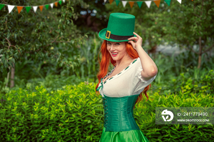 Happy Irish young red-haired woman in a green Leprechaun elf costume during a St. Patrick’s Day party. Ireland National Independence Day March 17th