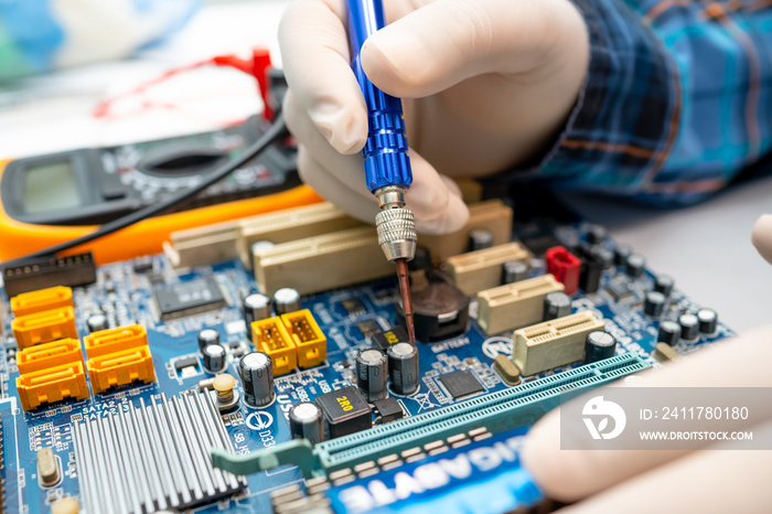 technician repairing inside of hard disk by soldering iron. Integrated Circuit. the concept of data, hardware, technician and technology.