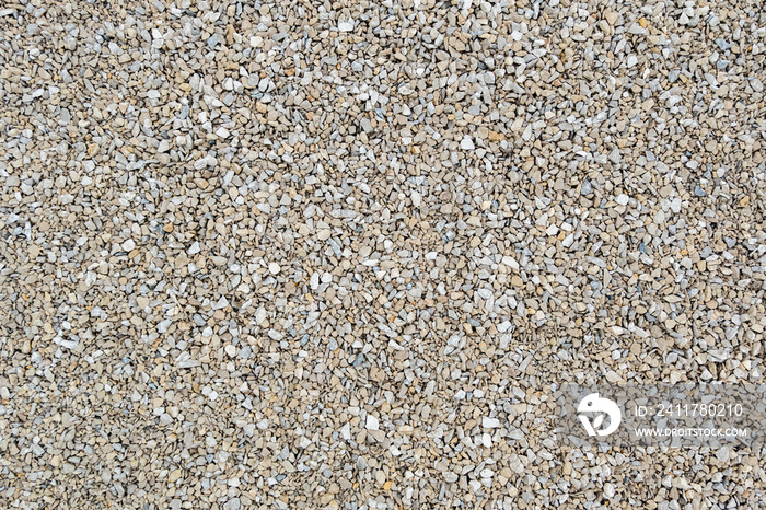 Dry white limestone ballast flat full frame background. Small gray dusty broken macadam stones texture.