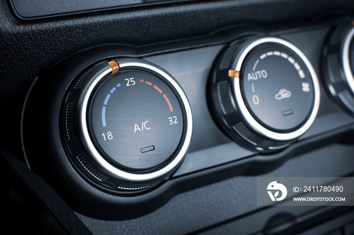 Air conditioner button for temperature climate adjustment in a car.
