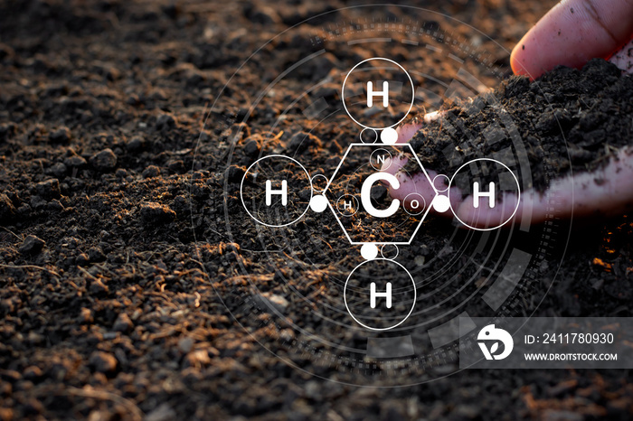 The man’s hand is pouring soil with various elements for planting and there is a technology icon around organic chemistry.