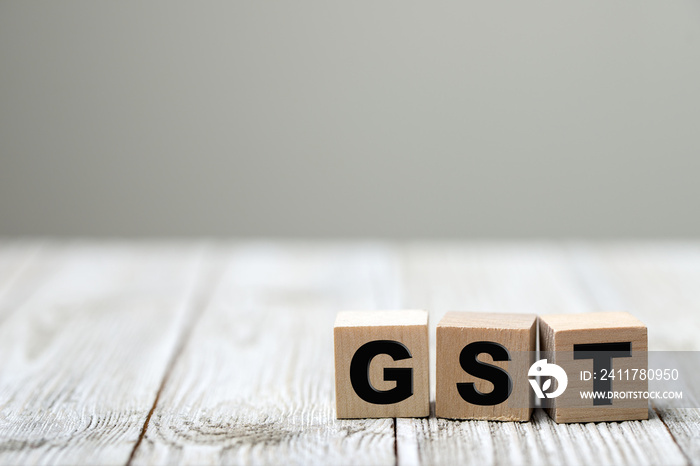 Business concept with a GST word on a wooden cube