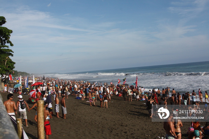 People at the beach in a party with the Costa Rica Flag during a surf contest