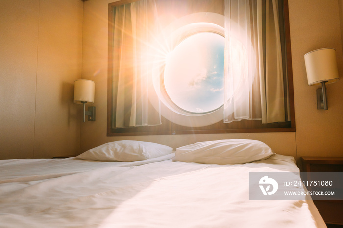 Natural Sunlight Shining Through Ship Window In Craft Cabin With Bed. View On Sea. Luxury Cabin On Ferry Boat Or Cruise Liner. Sea Cruise Vacation Trip Travel Concept