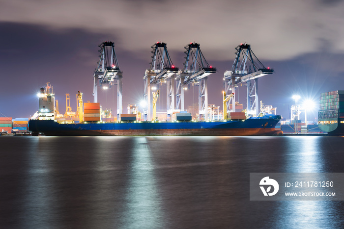 Industrial container freight and containers loading shipping by crane at Trade Port at night