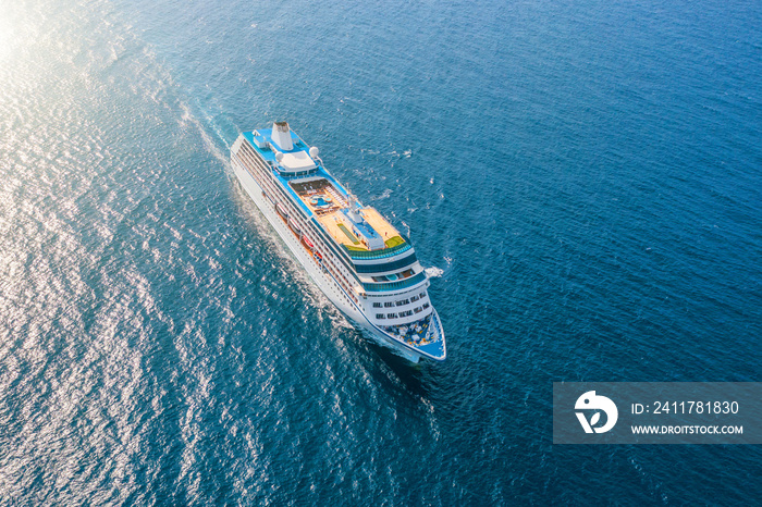 Cruise ship liner sails in the sea leaving a plume on the surface of the water seascape. Aerial view The concept of sea travel, cruises.