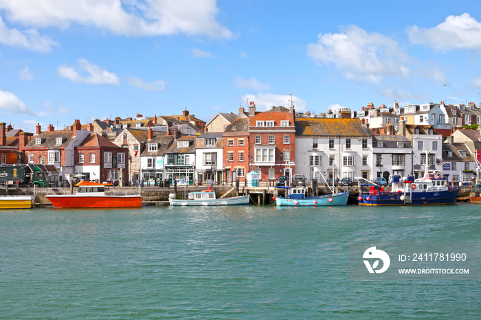 Sailing boats in the old town of Weymouth Harbour in Dorset, England, UK.